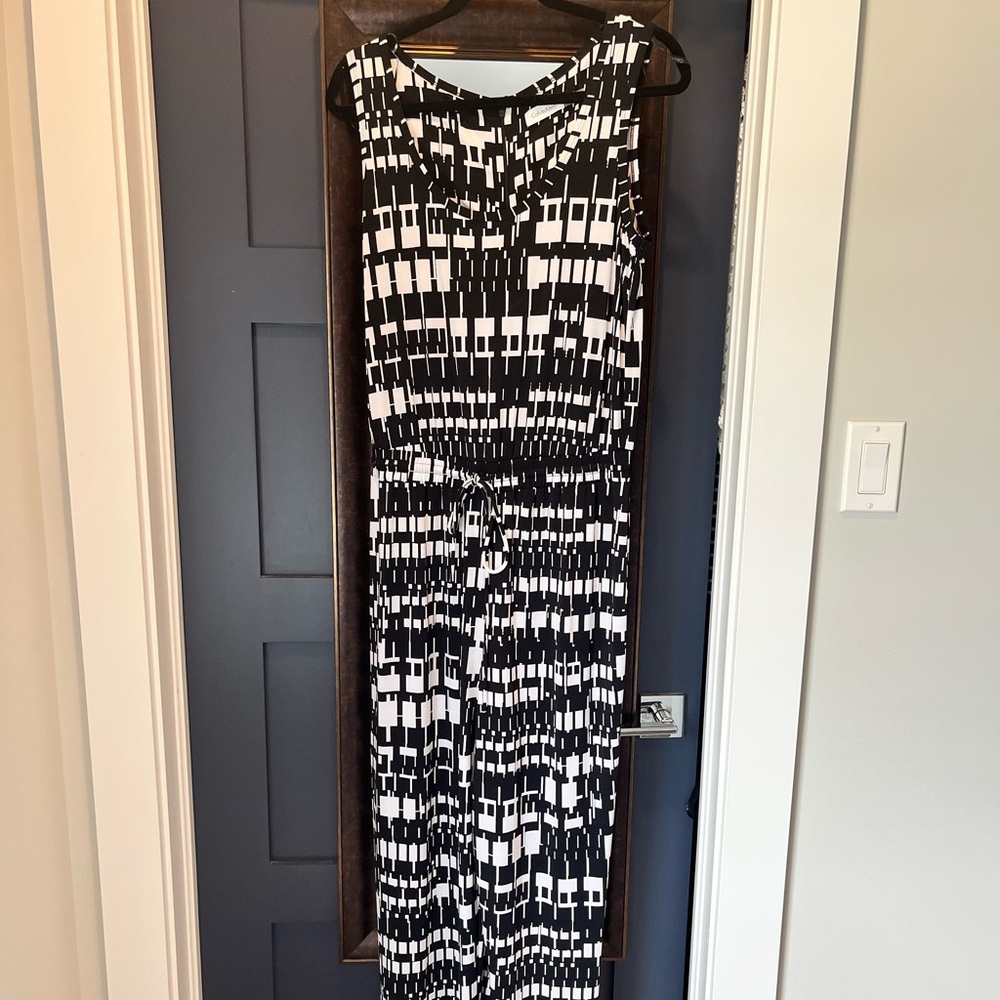 One piece jumpsuit with drawstring waist and back zipper. Worn only once.
